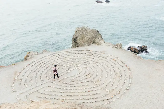 Frau in einem Labyrinth am Meer